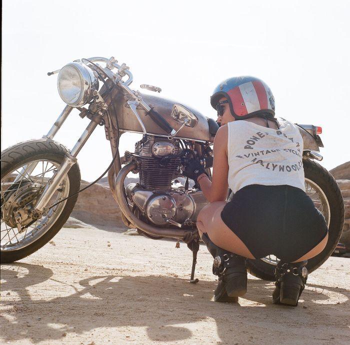 A playful frame from Girls on a motorcycle — online in Rome